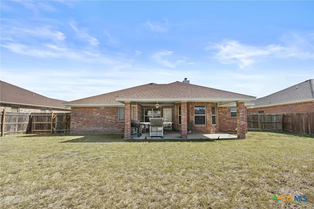 rear view of property featuring a patio and a yard