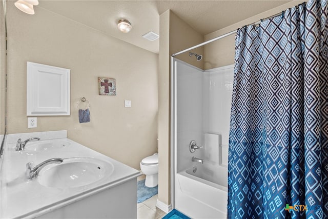 full bathroom with vanity, a textured ceiling, shower / bath combo, tile patterned flooring, and toilet