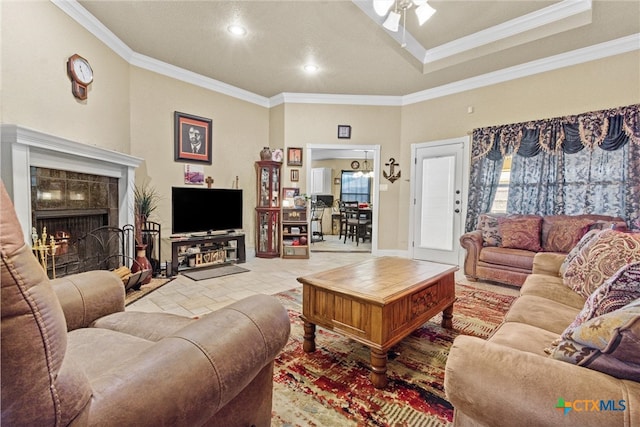 living room with ornamental molding and ceiling fan