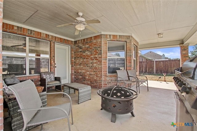 view of patio featuring an outdoor fire pit and ceiling fan