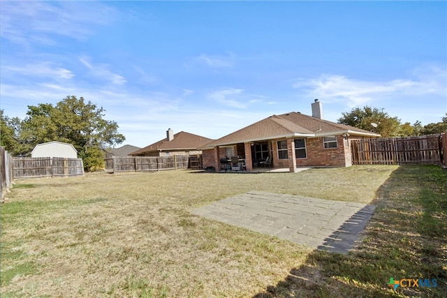 rear view of house featuring a patio area and a yard