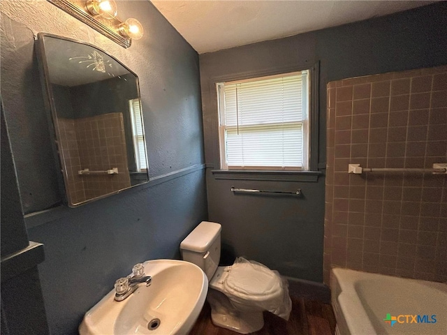 full bathroom featuring sink, plus walk in shower, and toilet