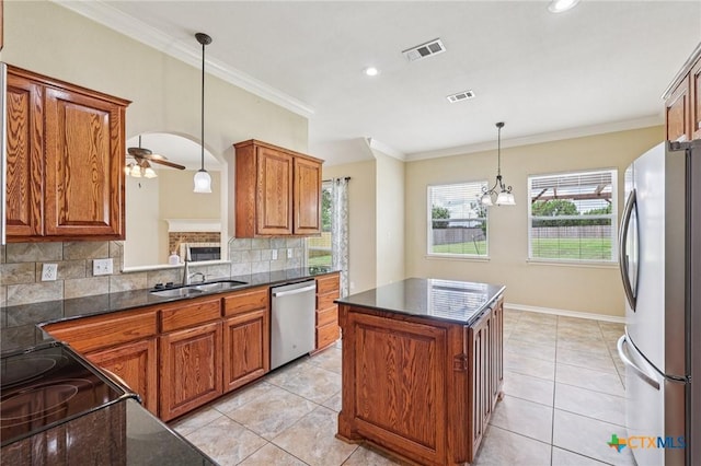 308 Cypress Springs Dr, Belton, TX 76513 - kitchen featuring stainless steel appliances, brown cabinets, ceiling fan, decorative backsplash, and ornamental molding
