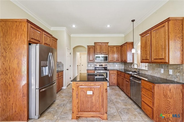 308 Cypress Springs Dr, Belton, TX 76513 - kitchen featuring appliances with stainless steel finishes, dark countertops, arched walkways, a center island, and crown molding