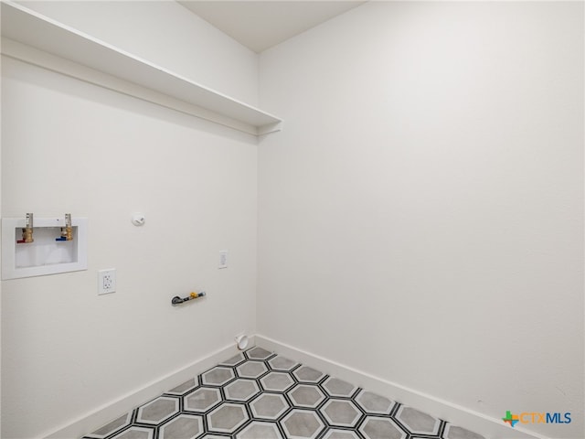 laundry room with gas dryer hookup, laundry area, hookup for a washing machine, and baseboards