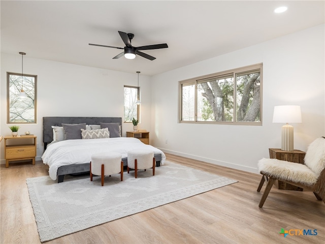 bedroom featuring light wood-style floors, recessed lighting, baseboards, and a ceiling fan