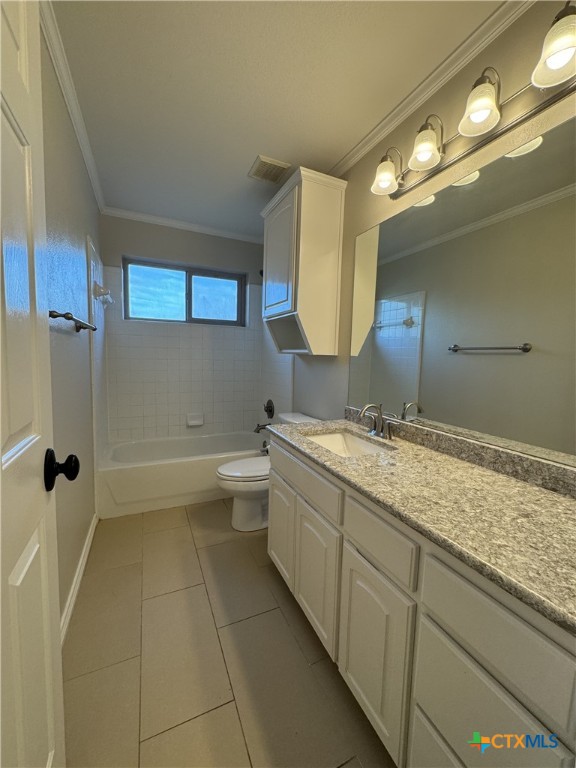 full bath featuring crown molding, shower / bath combination, visible vents, vanity, and tile patterned flooring