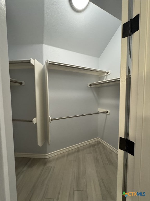 spacious closet featuring wood finished floors