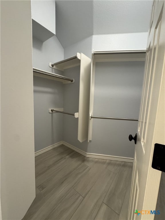 spacious closet with wood finished floors