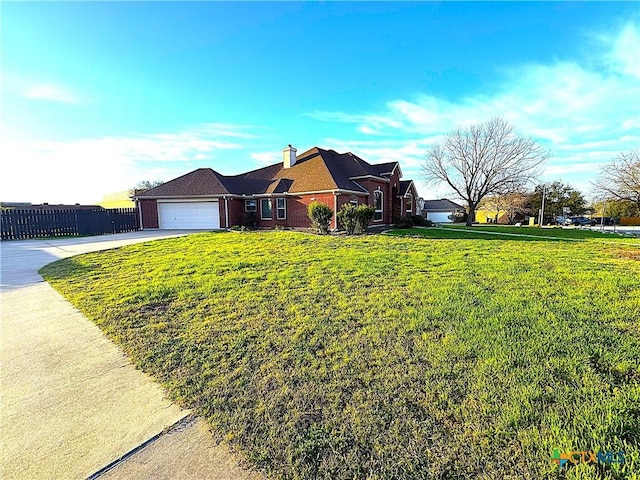 view of front of house with brick siding, concrete driveway, a front yard, fence, and a garage