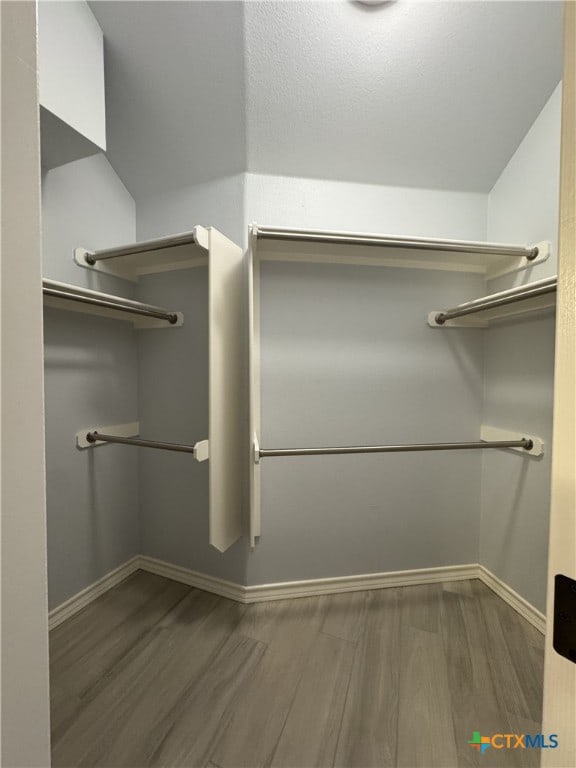 spacious closet with wood finished floors