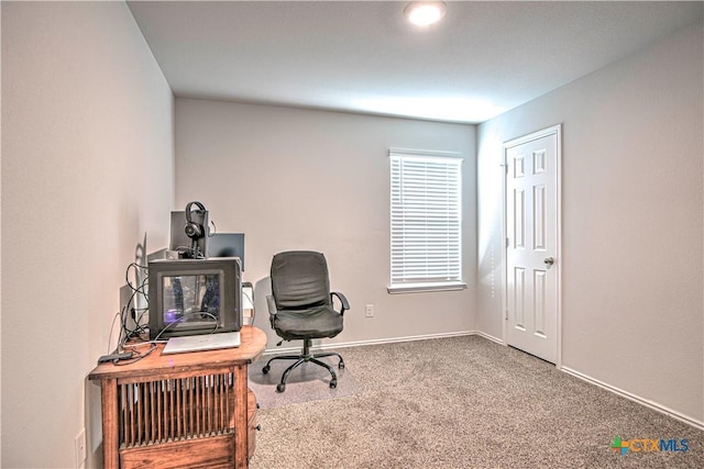 carpeted office space featuring baseboards