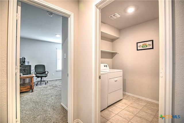 clothes washing area featuring visible vents, baseboards, light colored carpet, laundry area, and separate washer and dryer