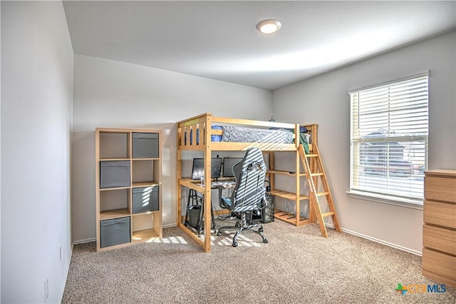 carpeted bedroom featuring baseboards