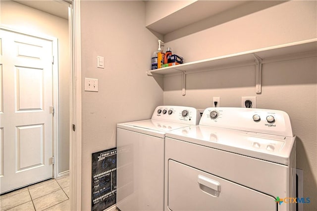 washroom with laundry area, light tile patterned floors, and independent washer and dryer