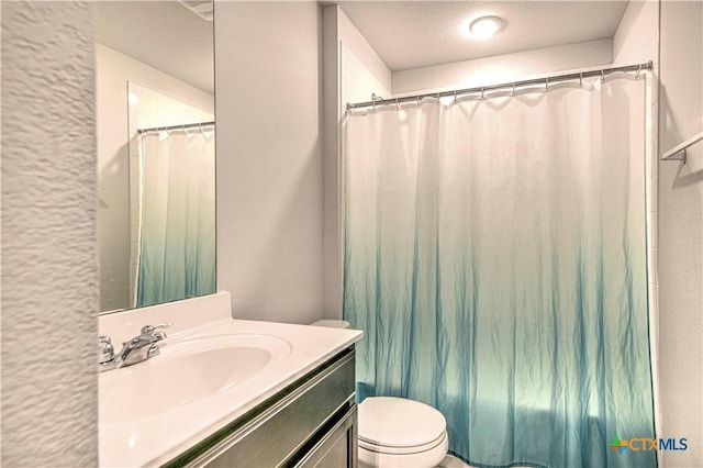 bathroom with vanity, shower / tub combo, a textured ceiling, toilet, and a textured wall