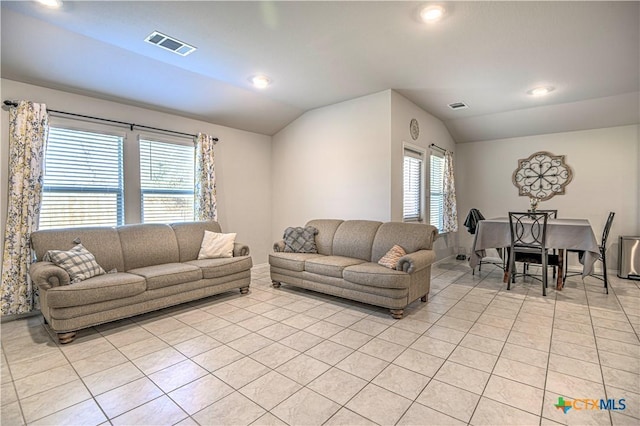 living area with light tile patterned floors, visible vents, lofted ceiling, and recessed lighting