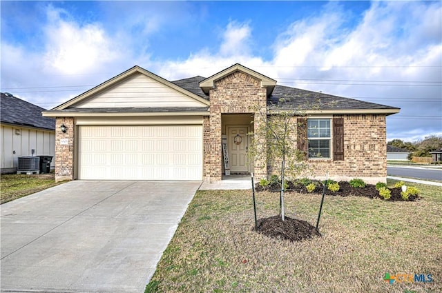 single story home featuring a front yard, brick siding, concrete driveway, and an attached garage