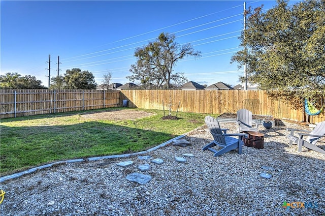 view of yard with an outdoor fire pit and a fenced backyard