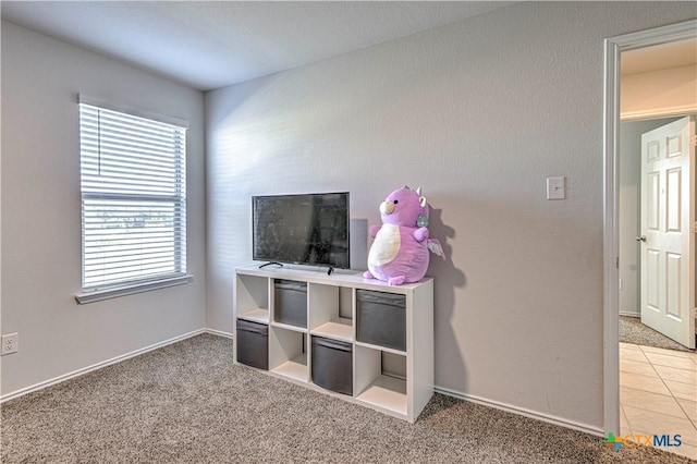 interior space featuring light tile patterned floors and light colored carpet