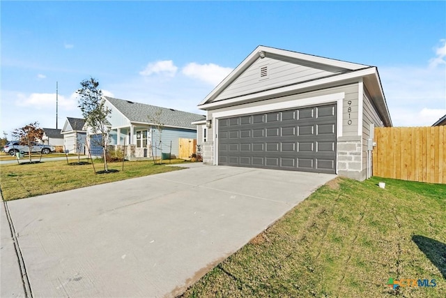 single story home with a garage and a front lawn