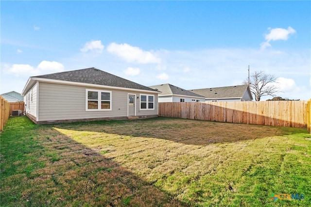 back of property featuring a lawn and central AC