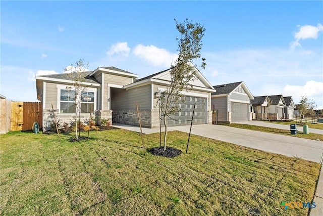 view of front of house featuring a garage and a front lawn