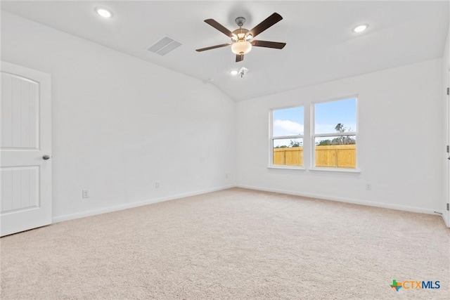 spare room featuring carpet flooring, ceiling fan, and lofted ceiling