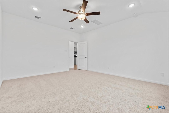 unfurnished room featuring ceiling fan, light colored carpet, and lofted ceiling