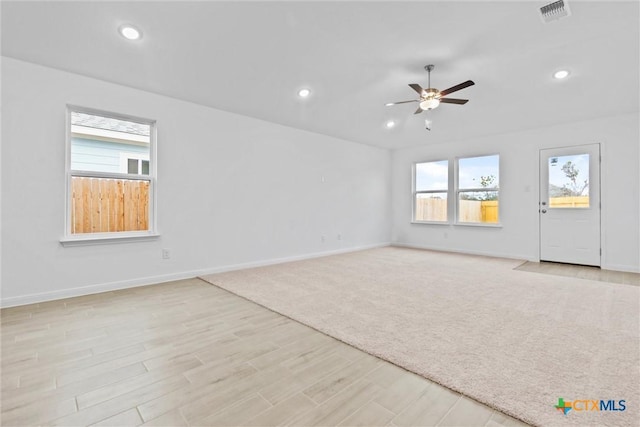 unfurnished living room with ceiling fan and light wood-type flooring