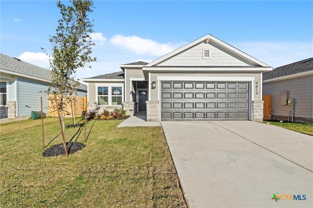 view of front of home featuring a front yard and a garage