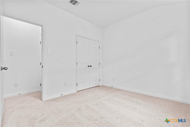 empty room with light colored carpet