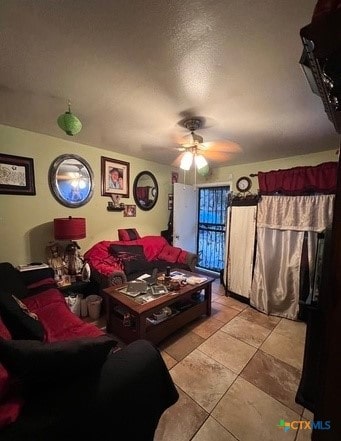 living room featuring ceiling fan and light tile patterned floors