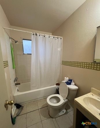 full bathroom with shower / tub combo with curtain, vanity, toilet, and tile patterned flooring