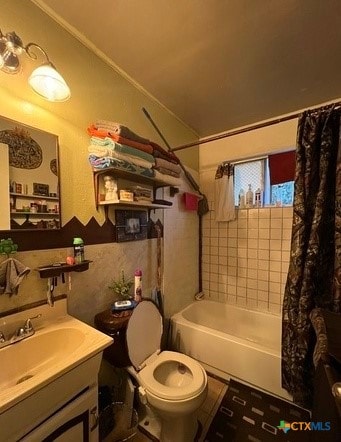 full bathroom with toilet, vanity, and shower / bath combo with shower curtain