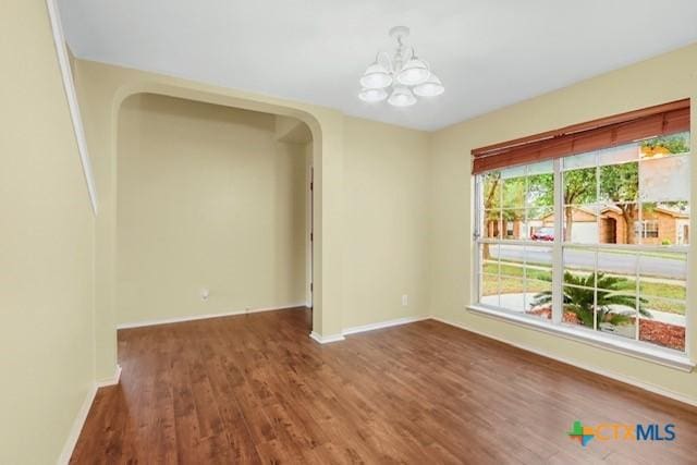 250 Val Verde Dr, New Braunfels, TX 78130 - unfurnished room featuring arched walkways, wood finished floors, and a chandelier