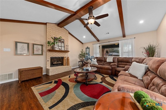 living room with lofted ceiling with beams, ceiling fan, dark hardwood / wood-style floors, and a fireplace