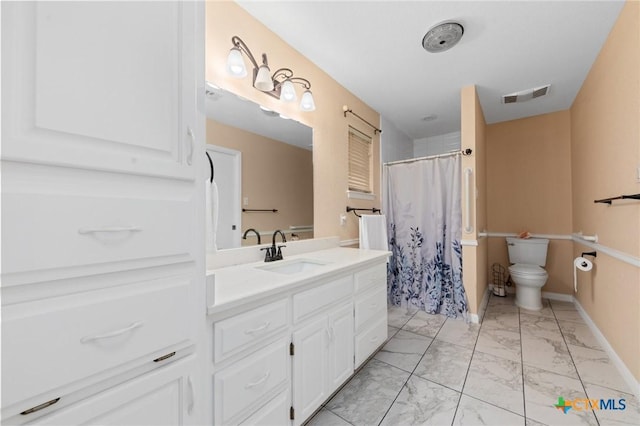 bathroom featuring vanity, walk in shower, and toilet