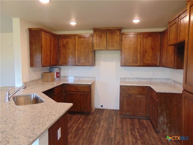 3204 Salt Fork Dr, Killeen, TX 76549 - kitchen with a sink, light stone countertops, dark wood-style floors, brown cabinetry, and recessed lighting