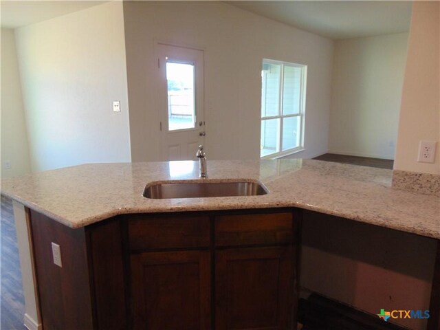 3204 Salt Fork Dr, Killeen, TX 76549 - kitchen featuring a sink, healthy amount of natural light, light stone countertops, and wood finished floors