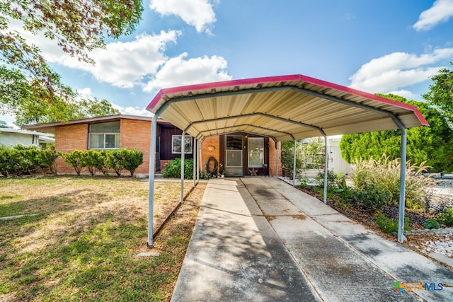 view of front of house with a front lawn and a carport