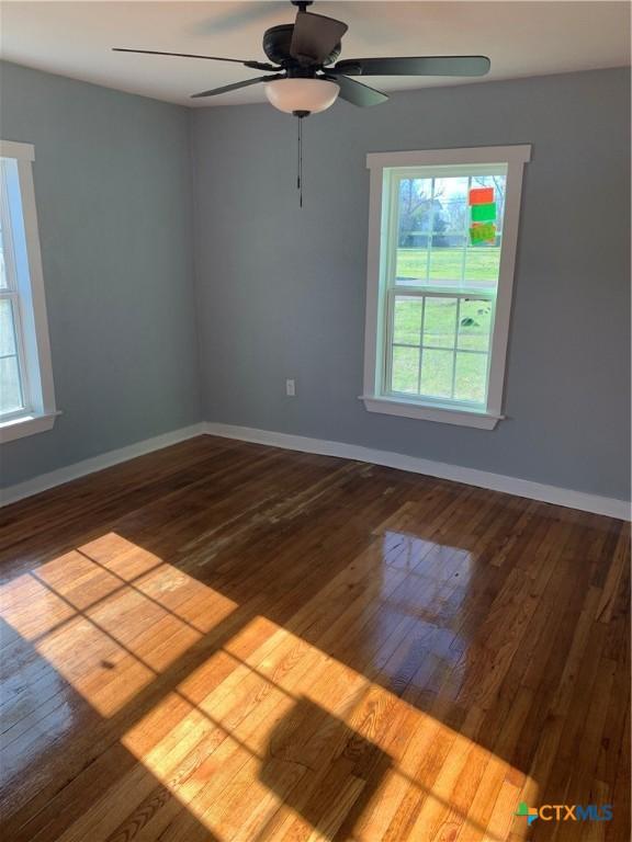 empty room featuring hardwood / wood-style flooring and ceiling fan