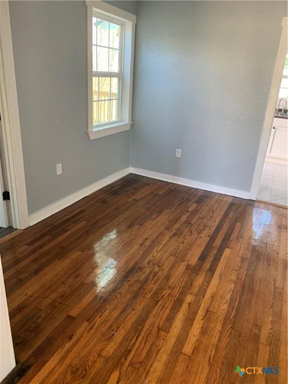 unfurnished room featuring dark hardwood / wood-style flooring