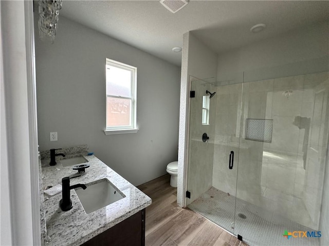 2571 Cedar Glen Dr, Belton, TX 76513 - full bathroom featuring double vanity, a stall shower, and wood finished floors