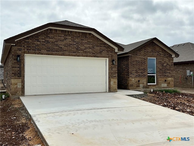 2571 Cedar Glen Dr, Belton, TX 76513 - ranch-style home with brick siding, driveway, an attached garage, and a shingled roof