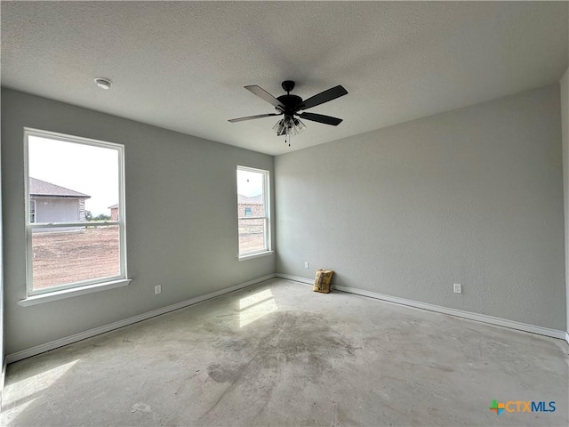 2571 Cedar Glen Dr, Belton, TX 76513 - empty room with unfinished concrete flooring, a ceiling fan, and a textured ceiling