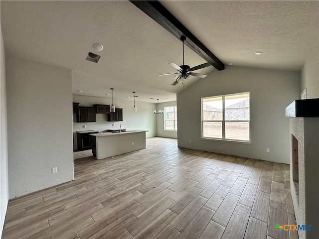 2571 Cedar Glen Dr, Belton, TX 76513 - unfurnished living room with light wood finished floors, ceiling fan, a textured ceiling, and a fireplace