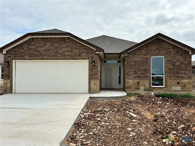 2571 Cedar Glen Dr, Belton, TX 76513 - ranch-style house featuring brick siding, an attached garage, concrete driveway, and roof with shingles