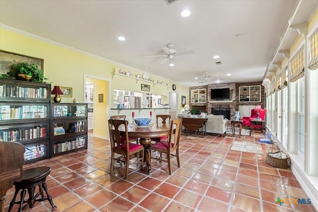 13650 Blackberry Rd, Salado, TX 76571 - dining room featuring a brick fireplace, recessed lighting, ceiling fan, tile patterned floors, and ornamental molding