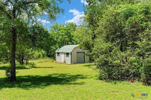 13650 Blackberry Rd, Salado, TX 76571 - view of green lawn featuring a storage unit and a forest view
